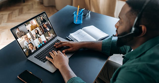 <p>Business brainstorm, online video meeting, virtual conference with multiracial colleagues. African American man communicate with business partners by video call uses laptop and app, work from home</p>
